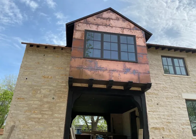 Copper metal panel facade on a stone building for Skylight Installation in Adelanto